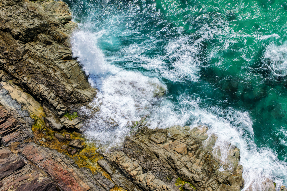 Aerial view of Burgess Beach in Forster, capturing jagged rocky coastline - Australian Stock Image