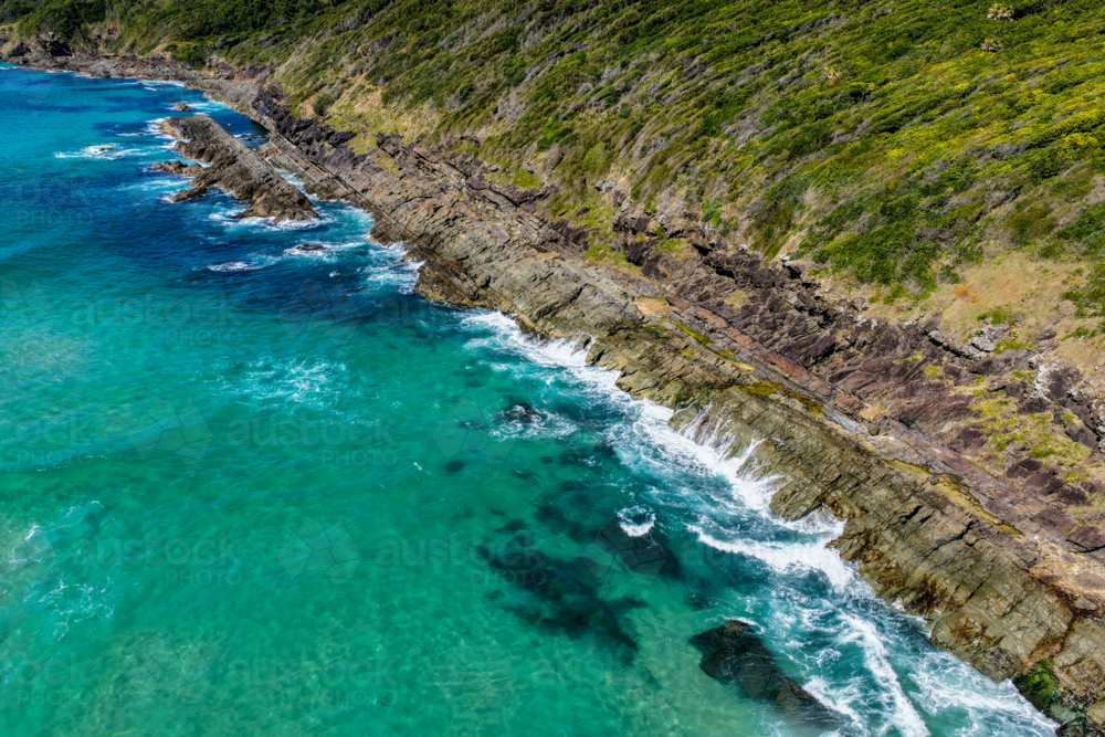 Aerial view of Burgess Beach in Forster, capturing jagged rocky coastline - Australian Stock Image