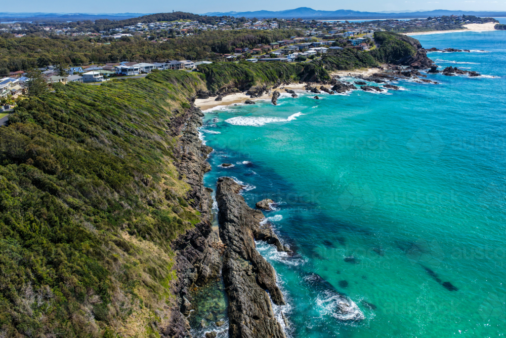 Aerial view of Burgess Beach in Forster, capturing jagged rocky coastline - Australian Stock Image