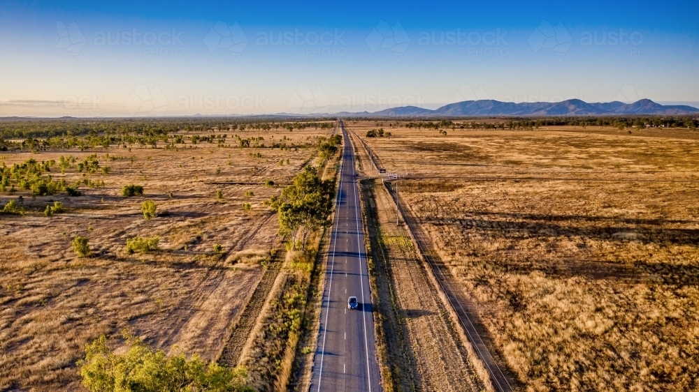 Aerial view of bush land and a  car on the highway in Mount Morgan during day time - Australian Stock Image
