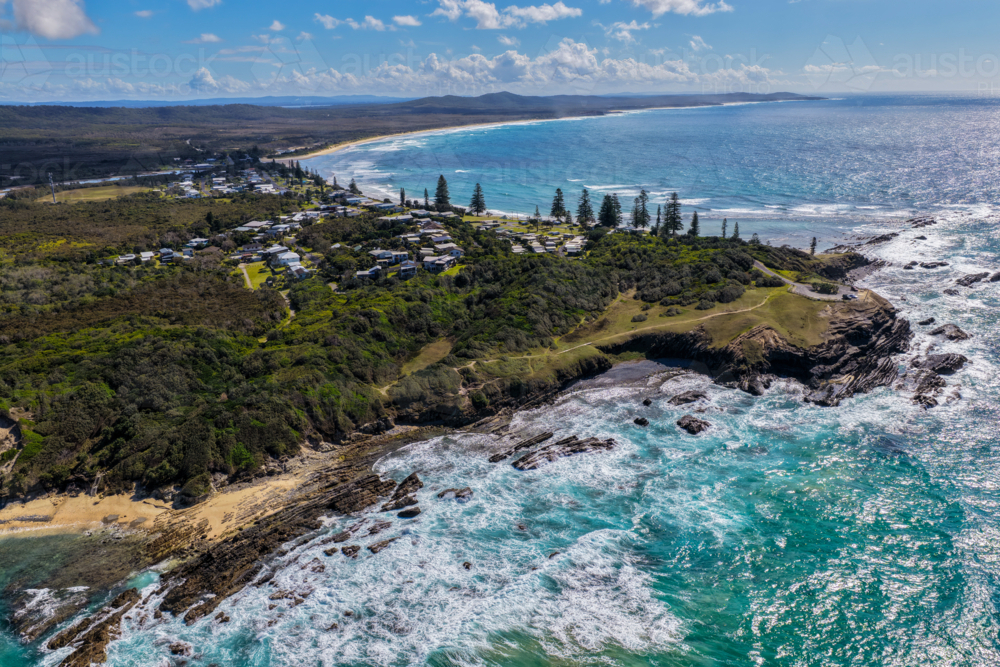 Aerial view of clear turquoise ocean water and rugged rocky coastline at Brooms Head - Australian Stock Image
