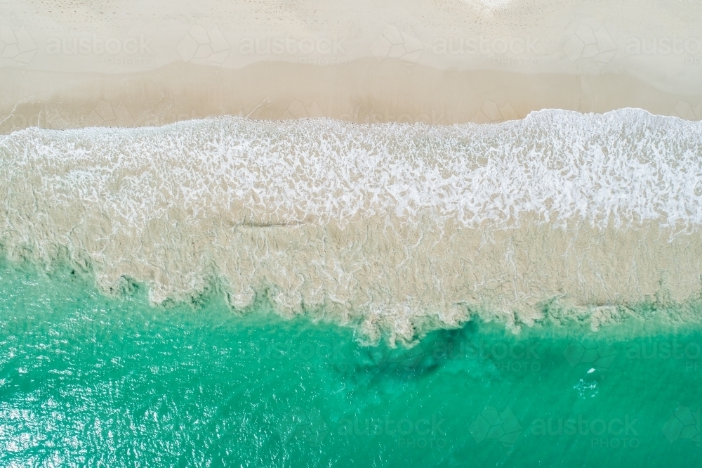 Image of Aerial view of clear water and sandy shore. - Austockphoto