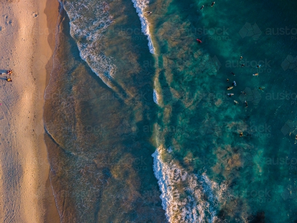 Aerial view of clear waves lapping on shore at North Beach, WA - Australian Stock Image