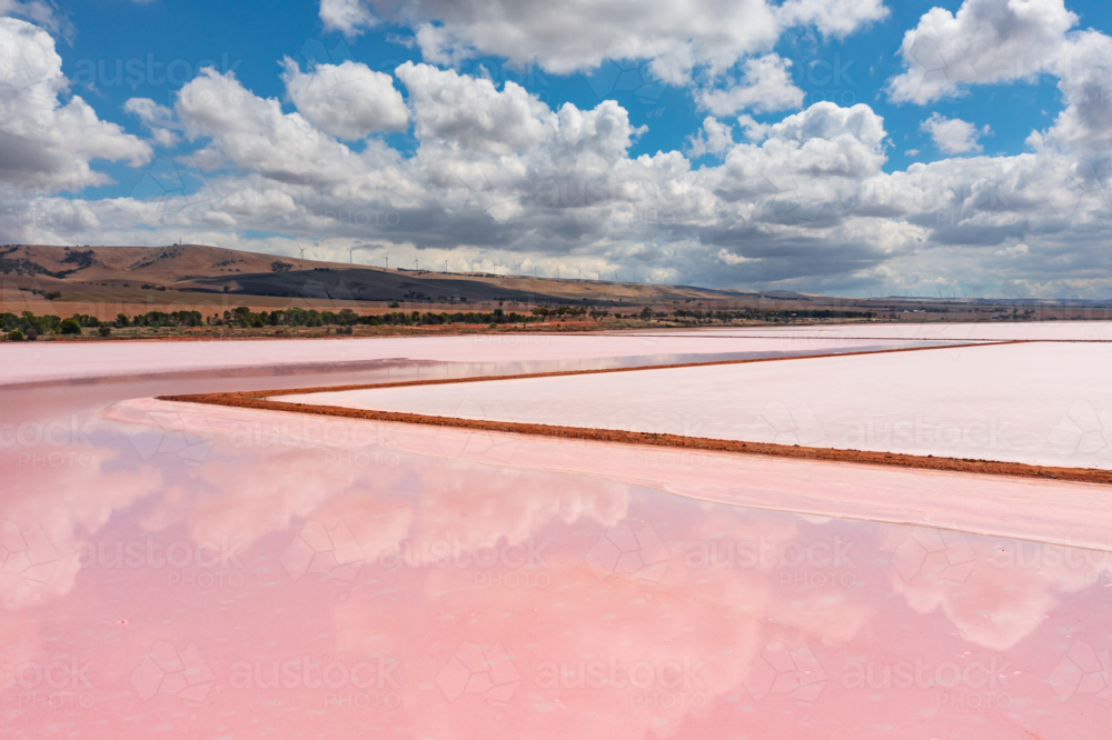 Aerial view of cloud reflections on the still surface of a colourful salt lake - Australian Stock Image