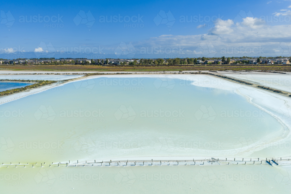 Aerial view of clouds reflected in a colourful coastal salt lake - Australian Stock Image