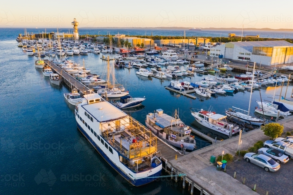 Aerial view of coastal marina full of boats, yachts and fishing vessels - Australian Stock Image