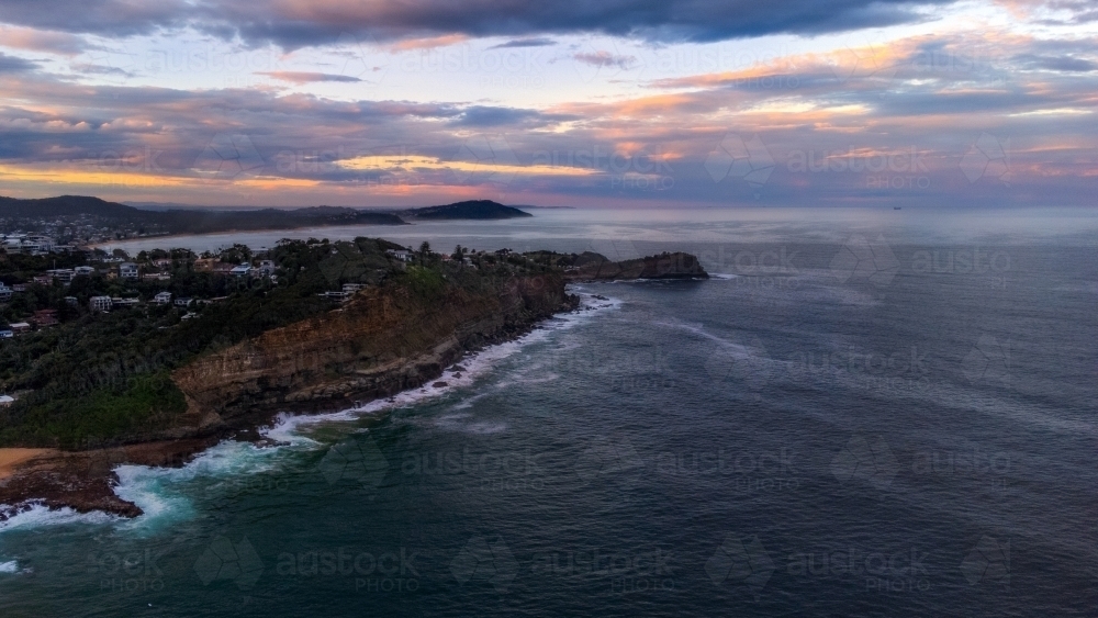 Aerial view of coastline at sunset - Australian Stock Image