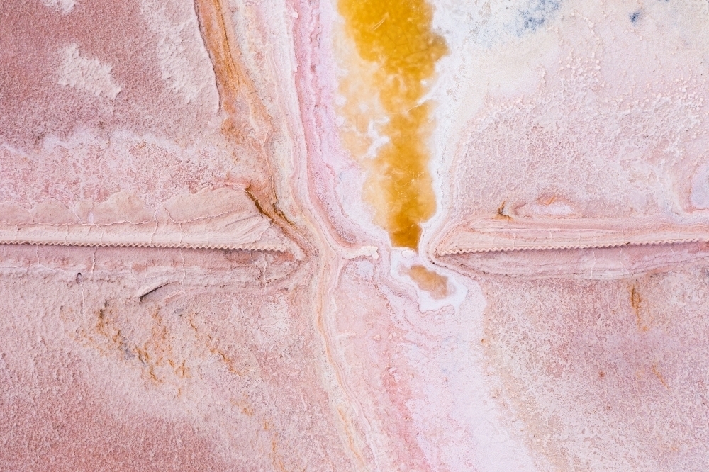 Aerial view of colourful patterns in a pink salt lake - Australian Stock Image