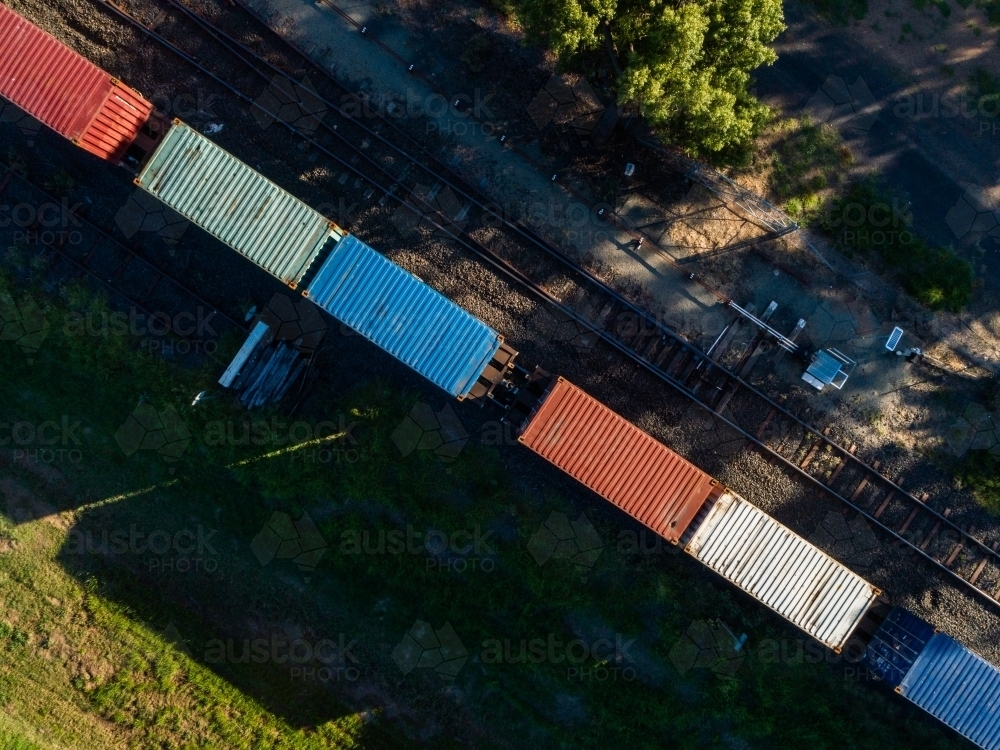 Aerial view of containers on a freight train in small Aussie town - Australian Stock Image