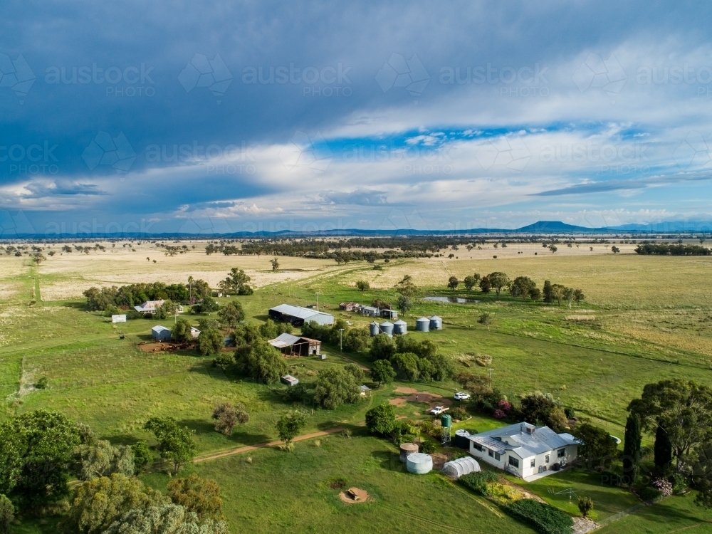 Aerial view of country farmhouse on green australian farm seen from aerial view - Australian Stock Image