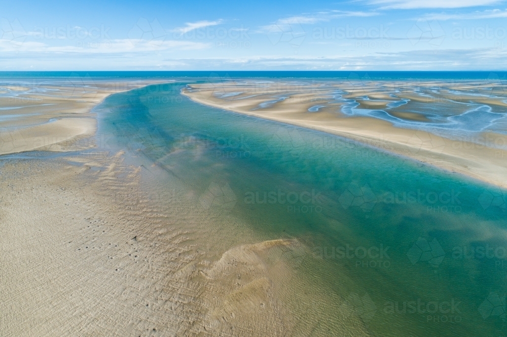 Image of Aerial view of creek and sandbar patterns in shallow blue ...