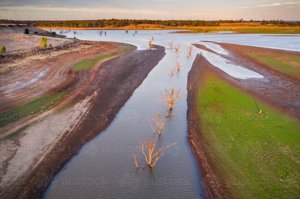 Aerial view of creeks and rivers flowing into a drying reservoir. - Australian Stock Image