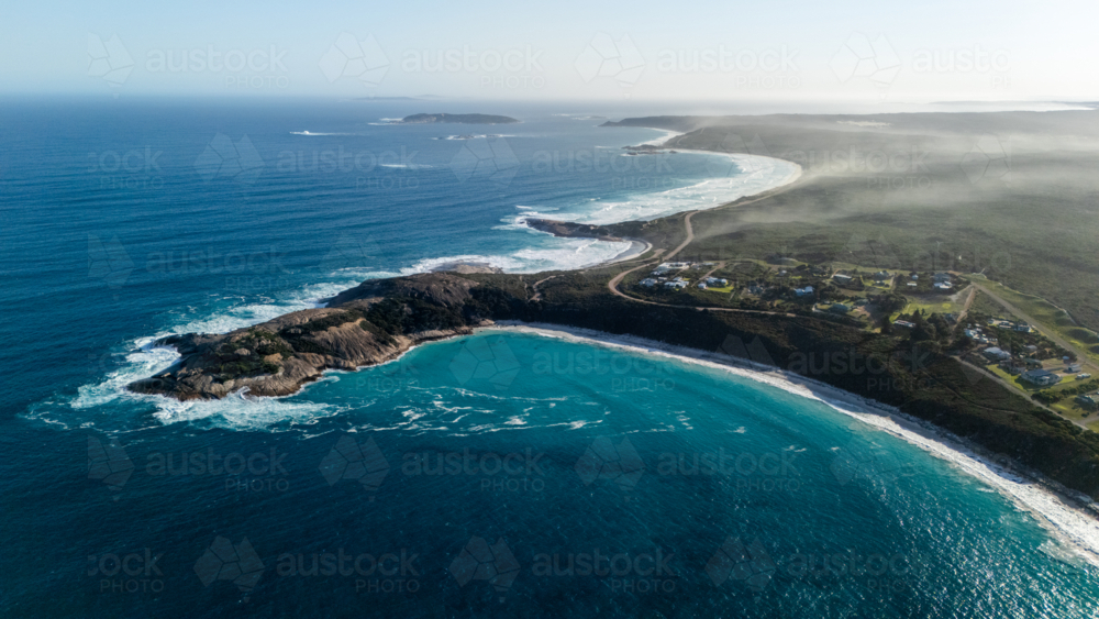Aerial view of crescent shapes shoreline with turquoise water - Australian Stock Image