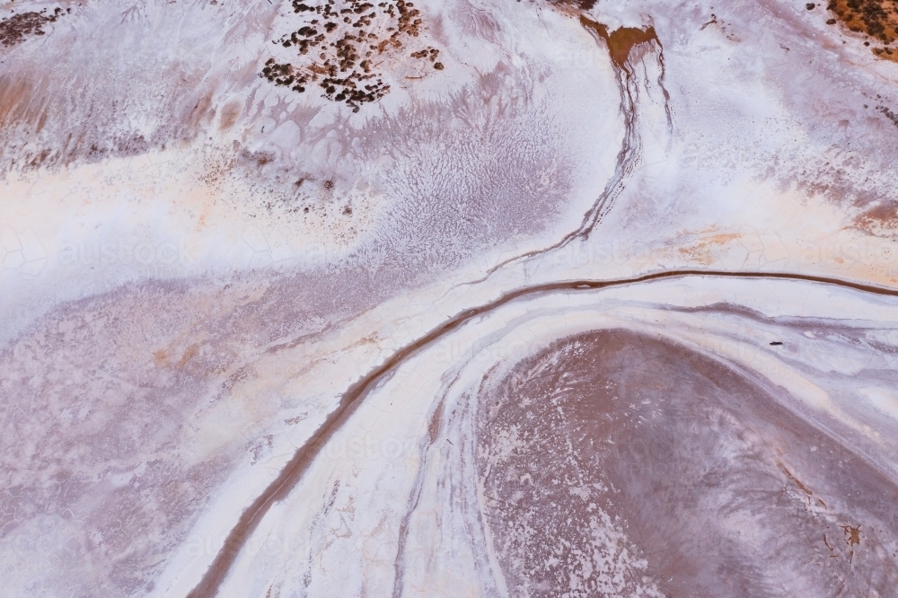 Aerial view of curved line patterns in dry salt lake - Australian Stock Image