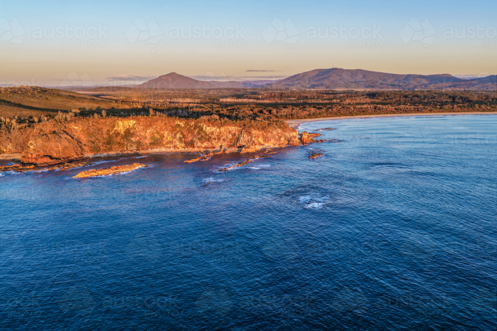 Aerial view of Diamond Head Beach and headland surrounded by ocean and coastal landscape - Australian Stock Image