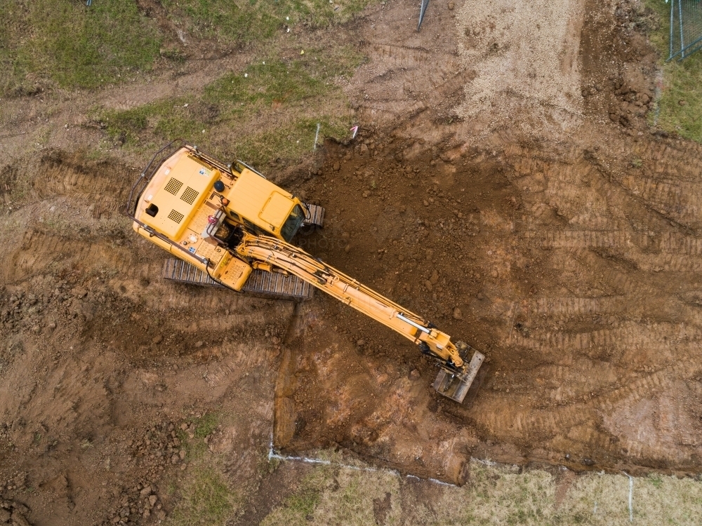 Aerial view of digger on house build construction site - Australian Stock Image
