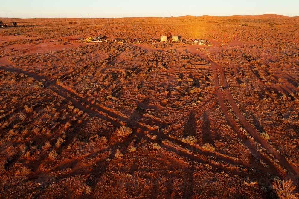Image of Aerial view of dirt tracks crossing a desert landscape with
