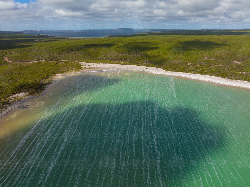 Aerial view of drift lines and cloud shadows on a windblown salt lake - Australian Stock Image