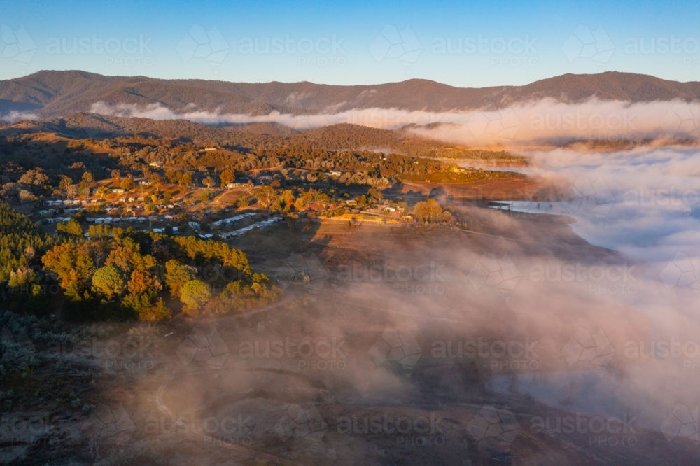 Image of Aerial view of early morning light on clouds of fog over an ...