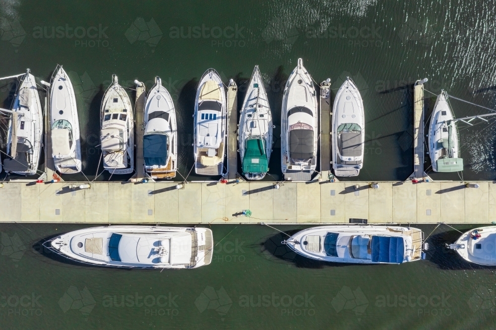Aerial view of expensive yachts lined up at a jetty - Australian Stock Image