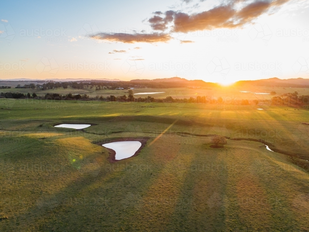 Aerial view of farm landscape with creek and dams in paddock - Australian Stock Image