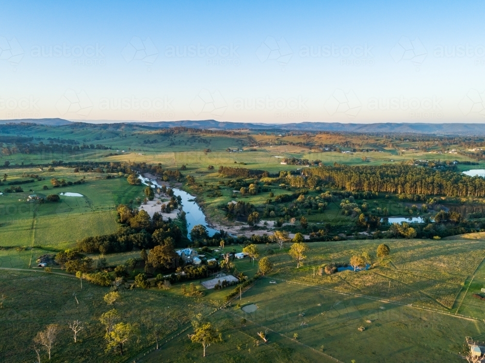 Aerial view of farms in Aberglasslyn over hunter river to Maitland Vale at dusk - Australian Stock Image
