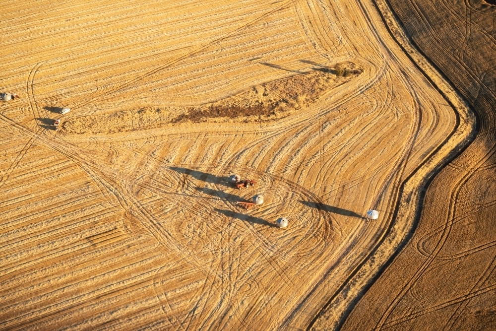 aerial view of field bins in harvested paddock - Australian Stock Image
