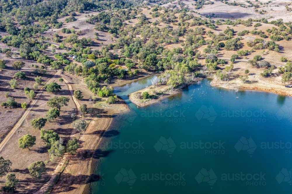 Aerial view of Glenbawn Dam and camping areas along the shoreline - Australian Stock Image