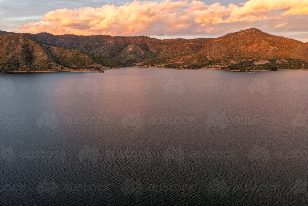 Aerial view of Glenbawn Dam at sunset in NSW Australia. Drone captures calm dam waters - Australian Stock Image