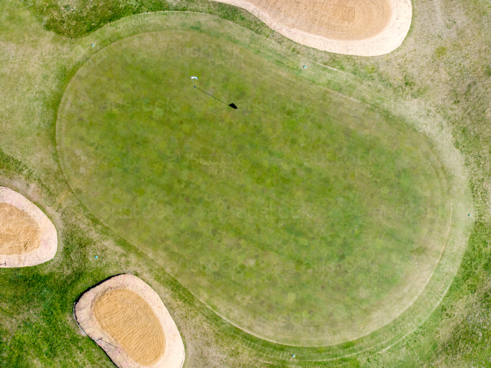 Aerial view of golf green surrounded by sand bunkers - Australian Stock Image