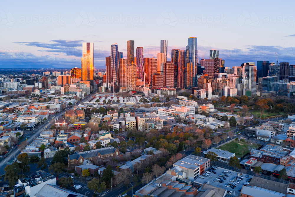 Aerial view of high rise buildings in a city skyline in golden evening lighting - Australian Stock Image