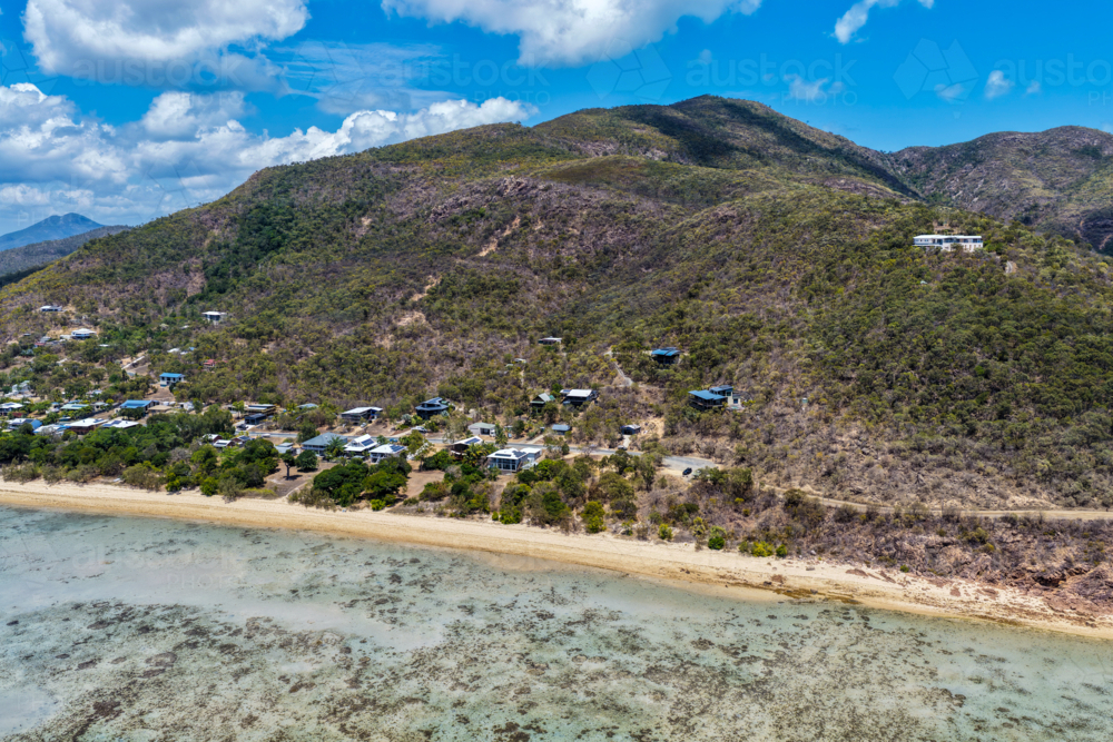 Aerial view of Hydeaway Bay showcasing its vibrant turquoise water, rocky headlands - Australian Stock Image