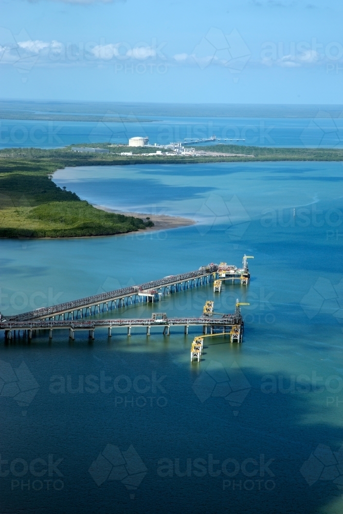 Aerial view of industrial wharves in harbour - Australian Stock Image
