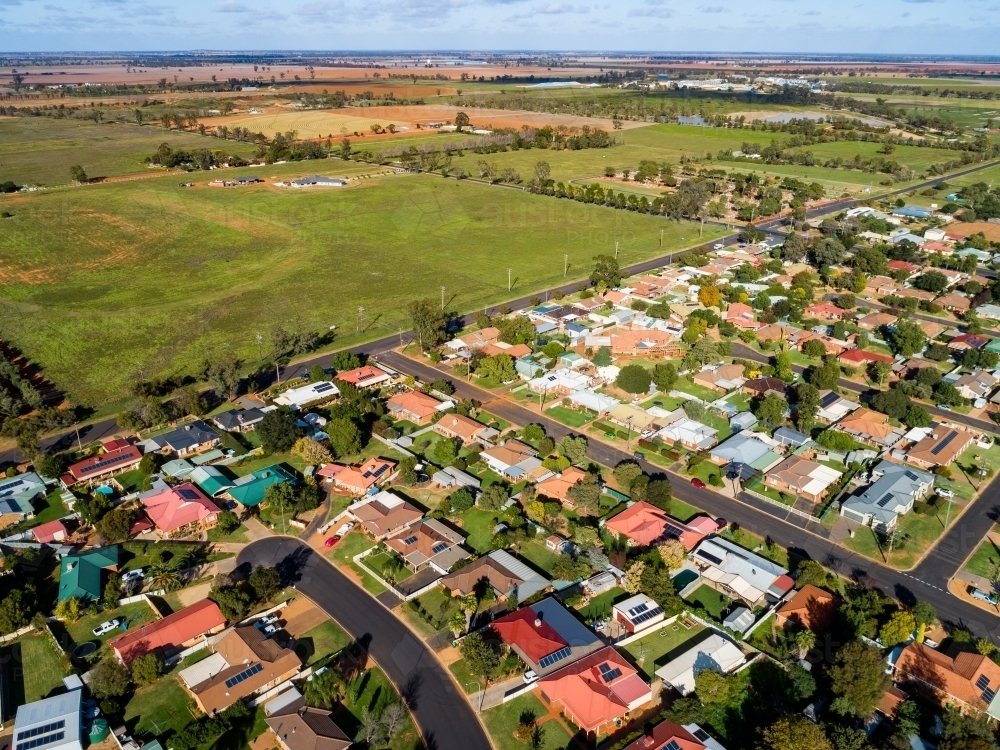 Aerial view of intersection of bush and built environment homes and farm paddocks - Australian Stock Image