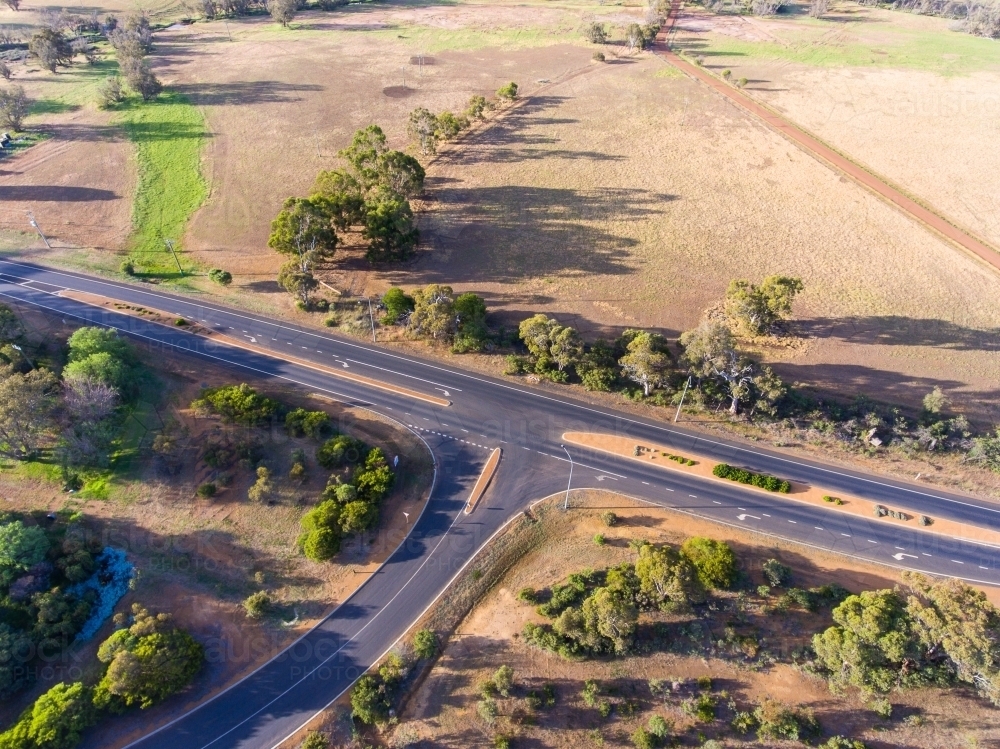 Image of aerial view of intersection on country highway - Austockphoto