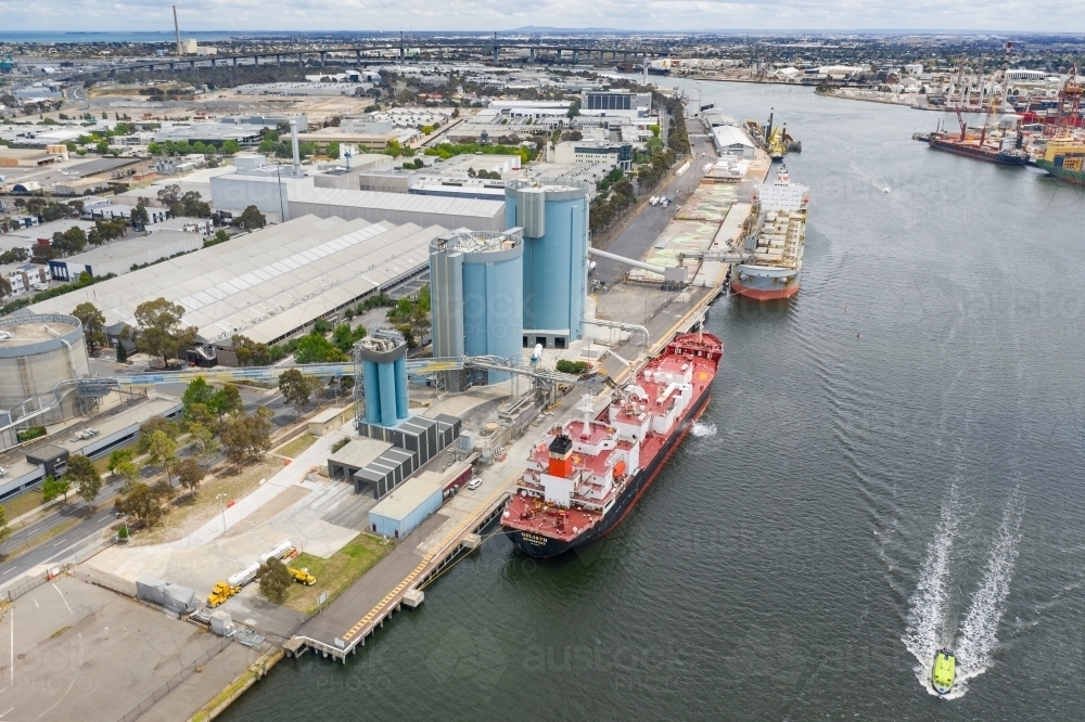 Aerial view of large cargo ships docked along a busy wharf - Australian Stock Image