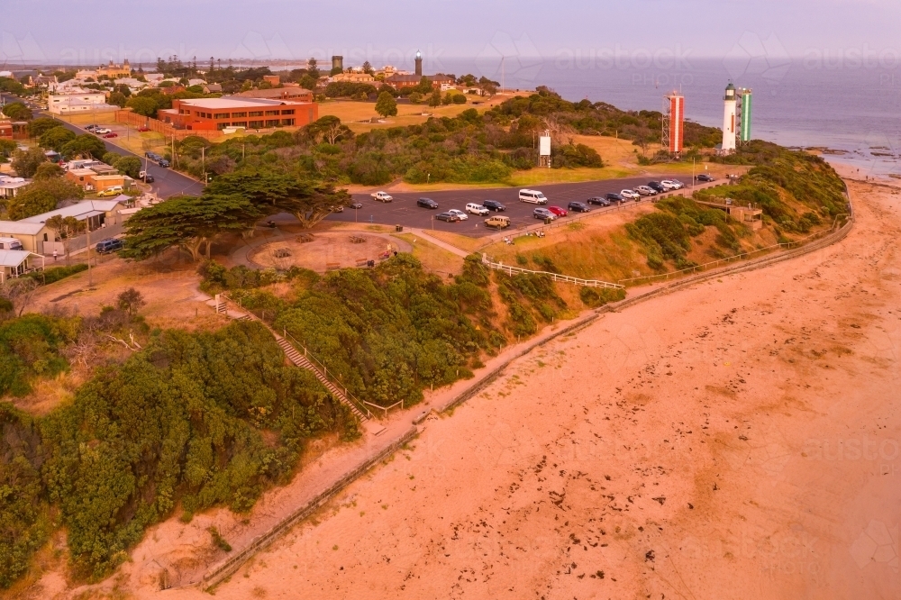 Aerial view of lighthouses and car park above a sandy beach at twilight - Australian Stock Image