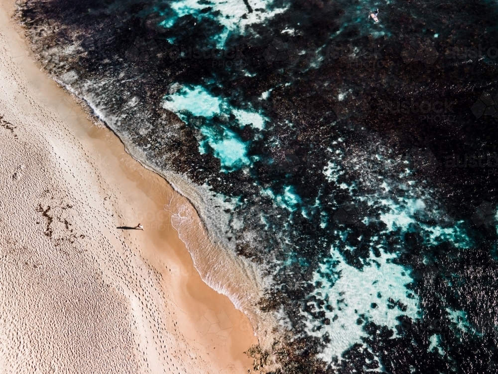 Aerial view of lone person walking along sand on North Beach, WA - Australian Stock Image