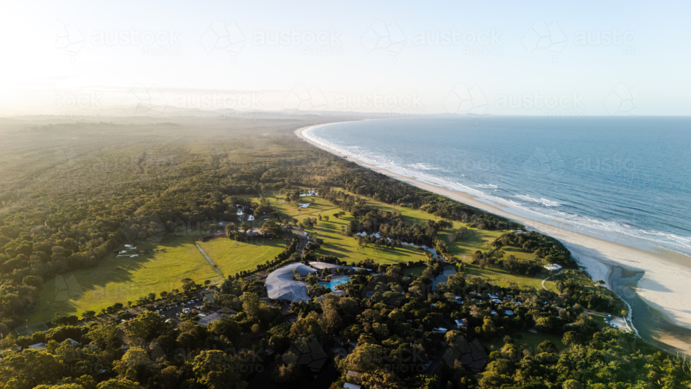 Aerial view of long stretch of white sand beach to distant horizon - Australian Stock Image