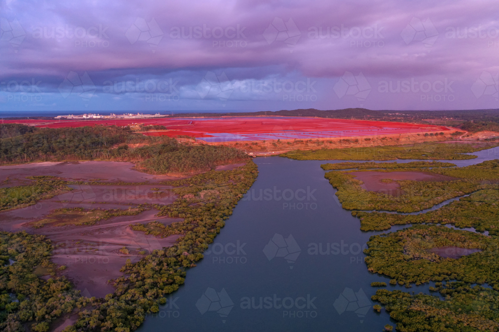 Aerial view of mangroves and industrial red soil - Australian Stock Image