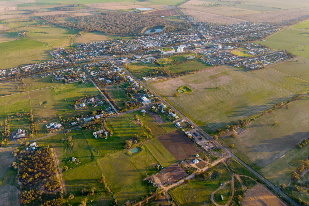 Aerial view of Nhill township surrounded by farmland at sunset - Australian Stock Image