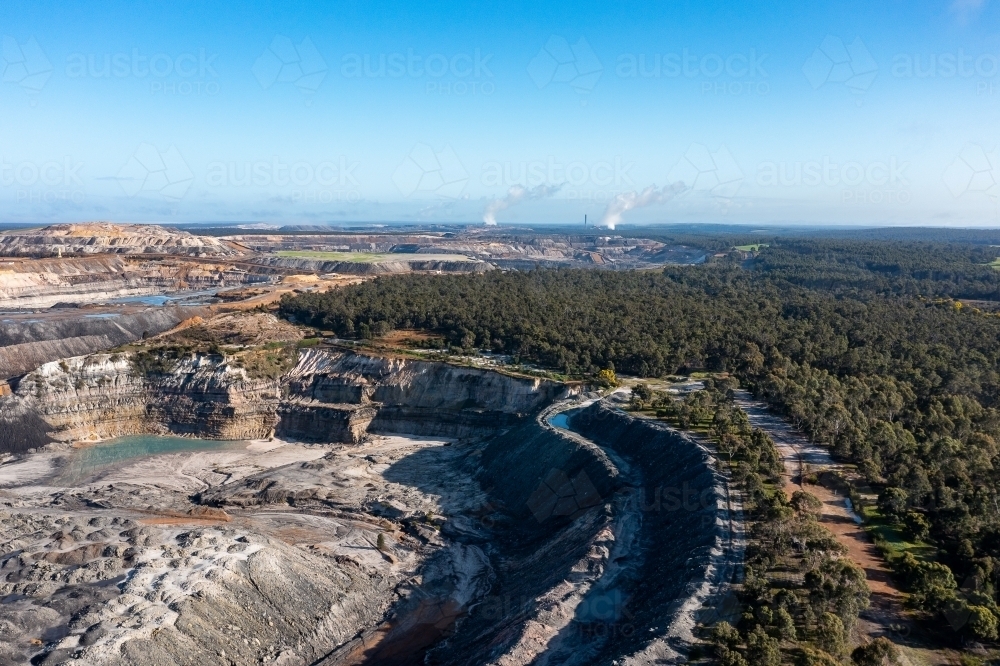 aerial view of open cut coal mine in forested area - Australian Stock Image