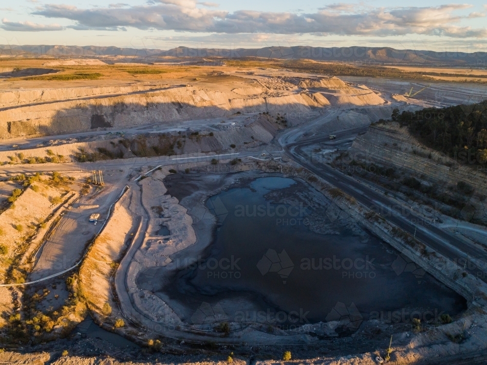 Aerial view of open cut coal mine with water near Singleton - Australian Stock Image