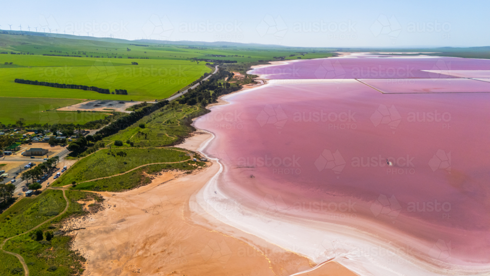Aerial view of pink lake with sandy shoreline. - Australian Stock Image