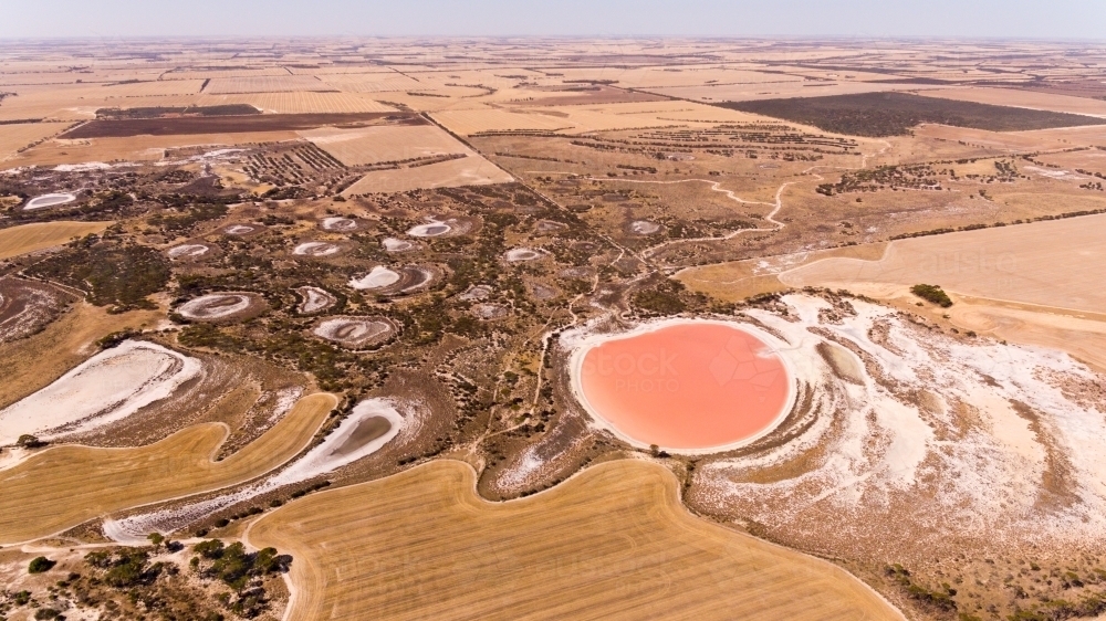 Aerial view of pink salt lake and agricultural land - Australian Stock Image