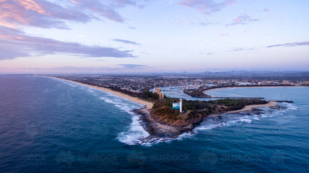 Aerial view of Point Cartwright lighthouse and water tank reservoir at sunrise. - Australian Stock Image