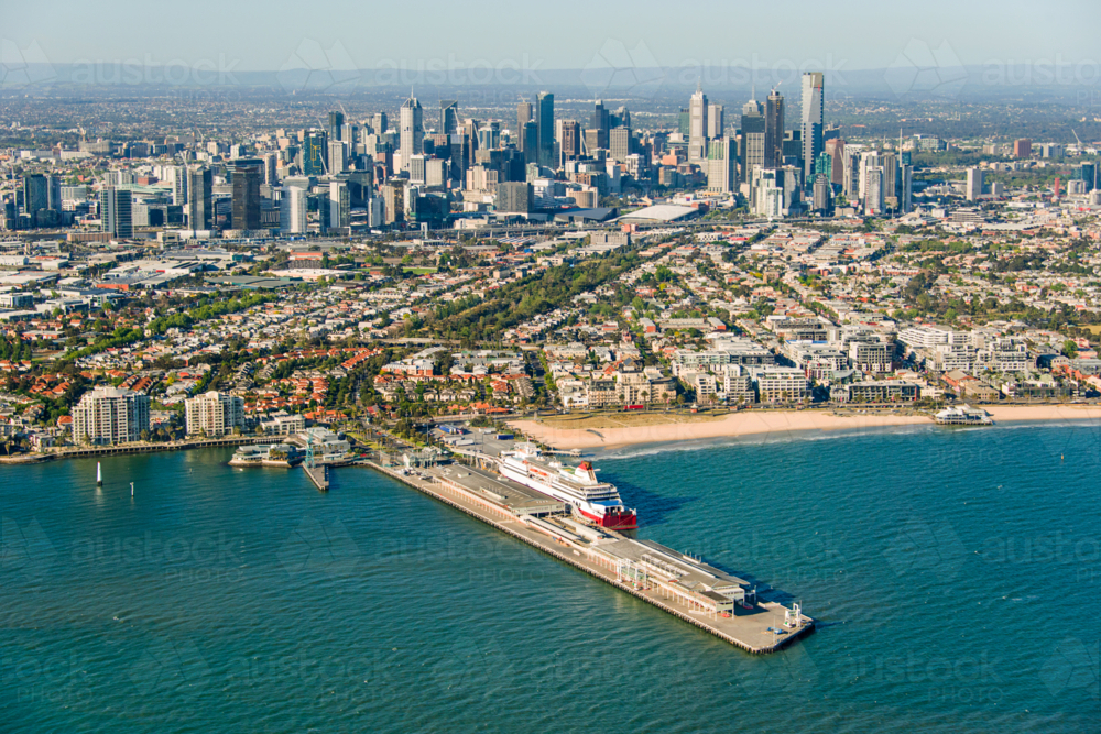 Aerial view of Port Melbourne with the Spirit of Tasmania docked and the city skyline - Australian Stock Image