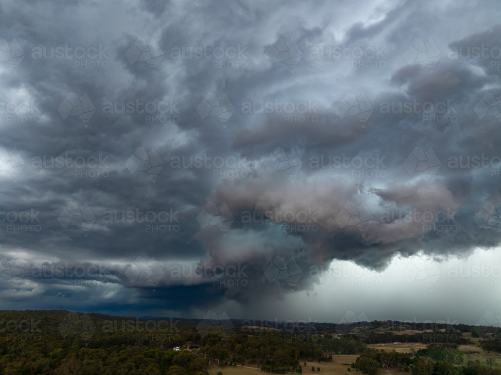 Aerial view of rain falling from a dark dramatic storm front - Australian Stock Image