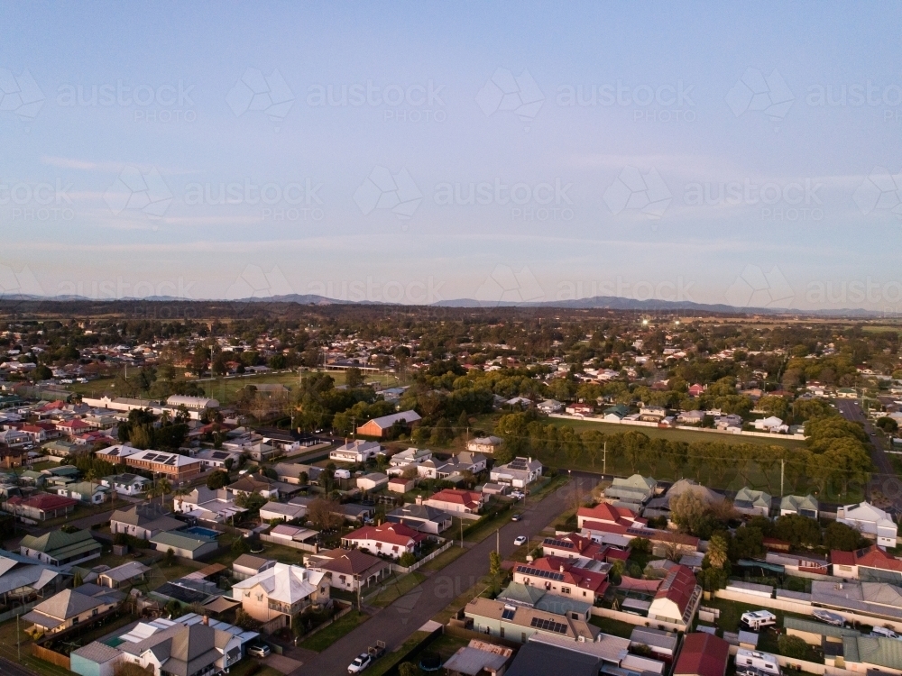 Aerial view of residential houses and streets at dusk - Australian Stock Image