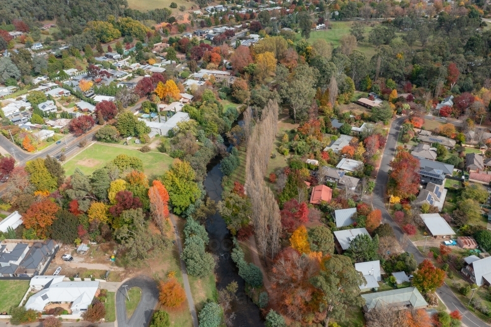 Image of Aerial view of river running through a regional town full of ...
